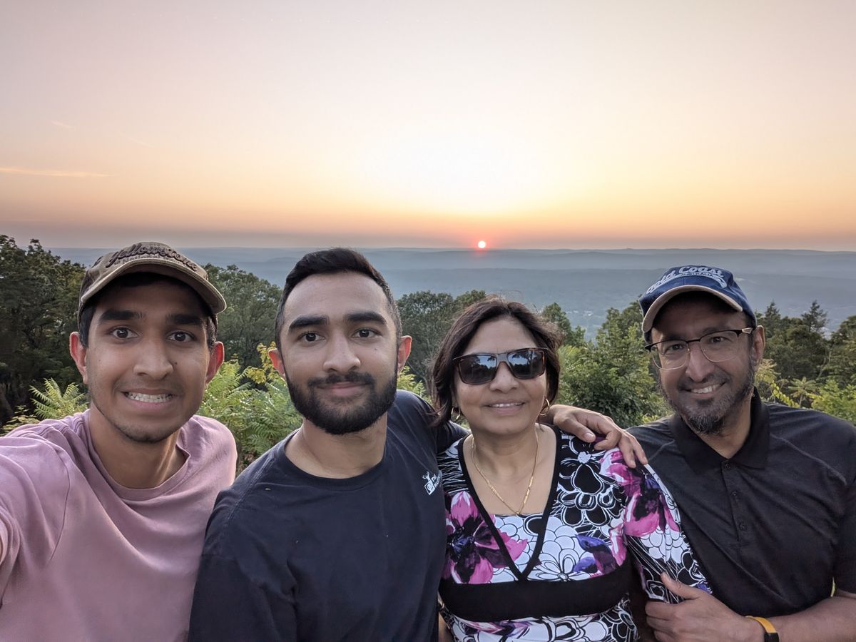 Family selfie of four at sunset